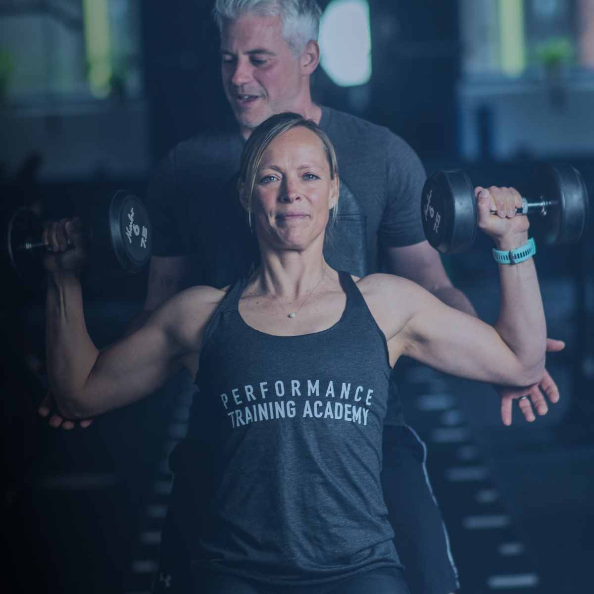 pt-course-landing-page-image A personal trainer training his client in a gym